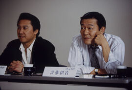 Two men sitting behind a desk
