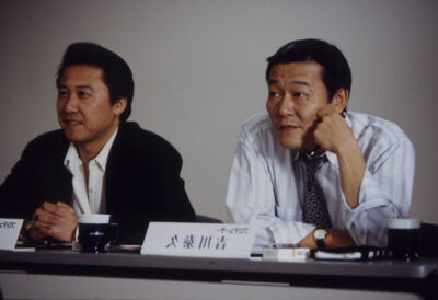 Two men sitting behind a desk