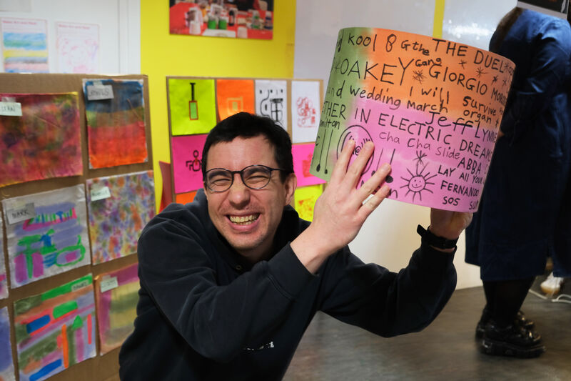 Person smiling white holding a lampshade