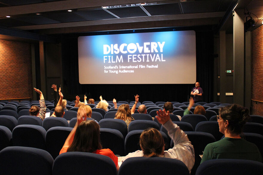 Teachers raising their hands to ask questions at the teachers preview 