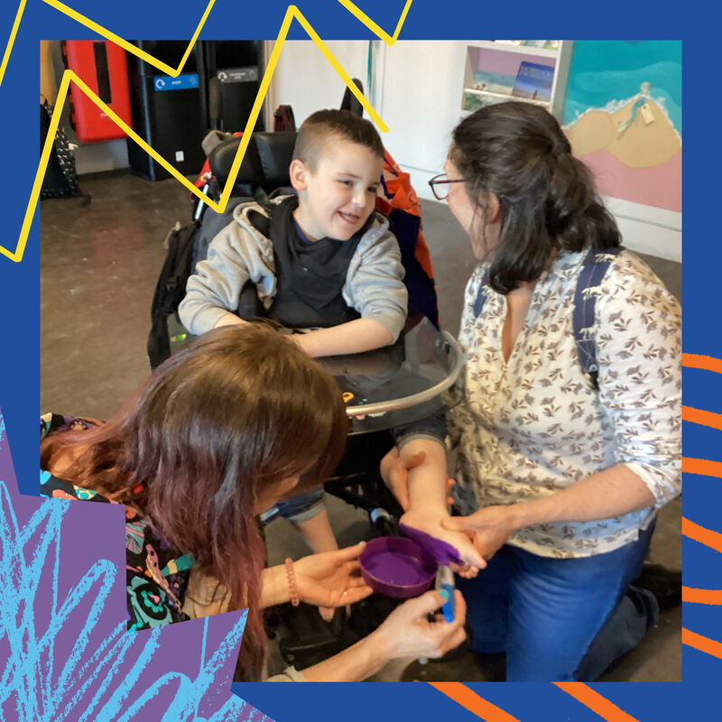 Child from Kingspark amiling getting tehir feet painted in DCA Create Space