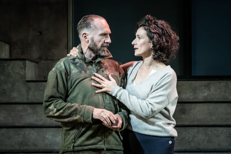 Ralph Fiennes and Indira Varma embrace in a contemporary version of Macbeth