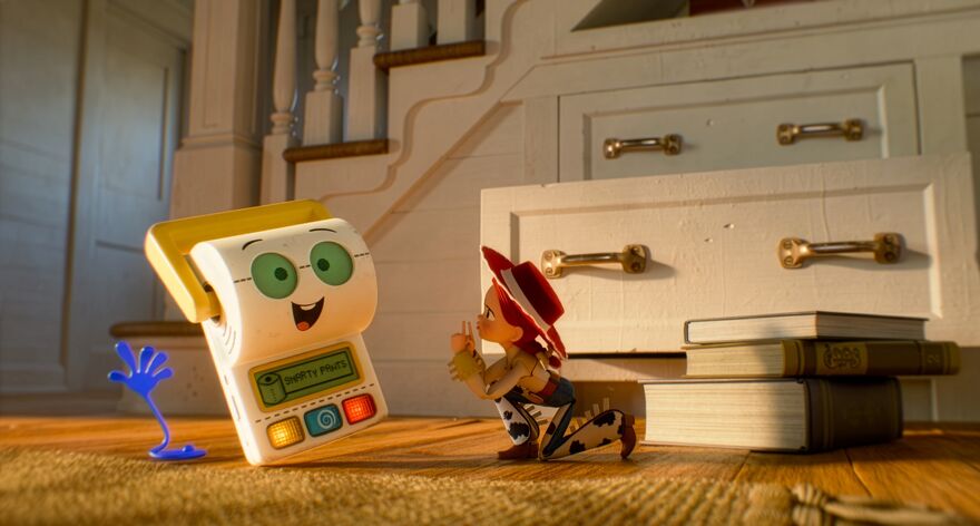 A female cowboy is on the floor shushing a toilet roll toy on the left. Behind them is a staircase and drawers with the bottom one open. Jessie is the female cowboy who features in Toy Story 2, 3, and 4.
