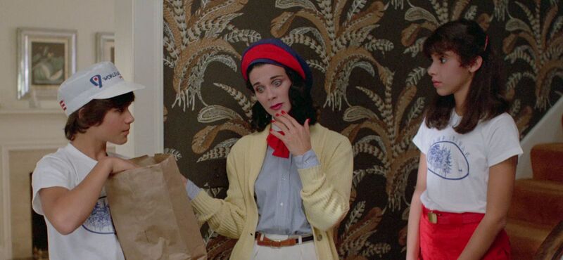 Two teenagers and an adult standing in a hall way