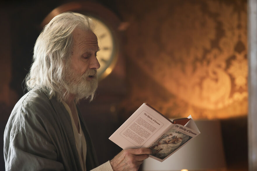 An elderly man reads from his own novel.