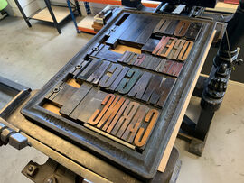 Press with wooden letters set up for letterpress printing