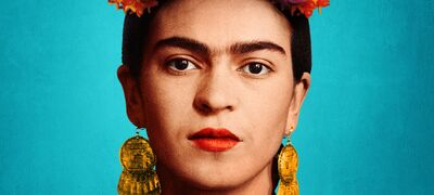 A close-up image of Frida Kahlo against a blue backdrop.