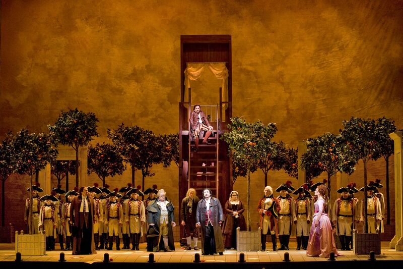 A group of singers on stage in beautiful costumes for Il Barbiere di Siviglia