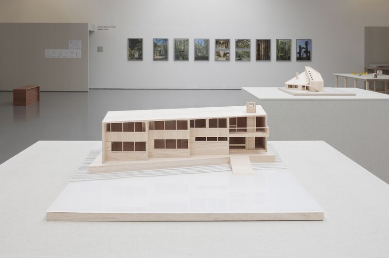 An architectural model of a building made out of wood.