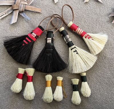 Selechtion of small and large brushes with different coloured thread