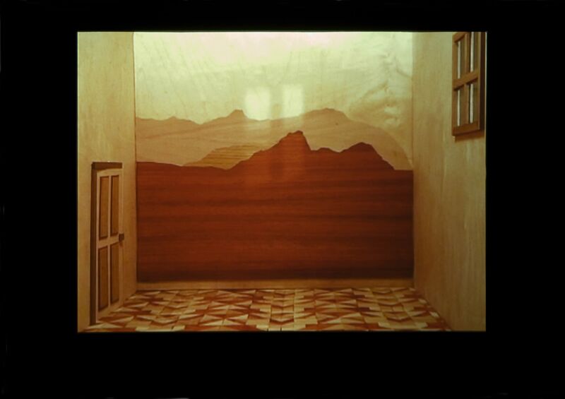 A red, orange and white room with mountain-like shapes on the wall. The floors are tiled with geometric tiles and there is a white door. From Cara Tolmie's exhibition.