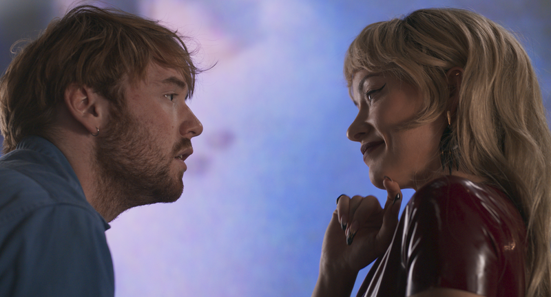 A young man stares at a woman