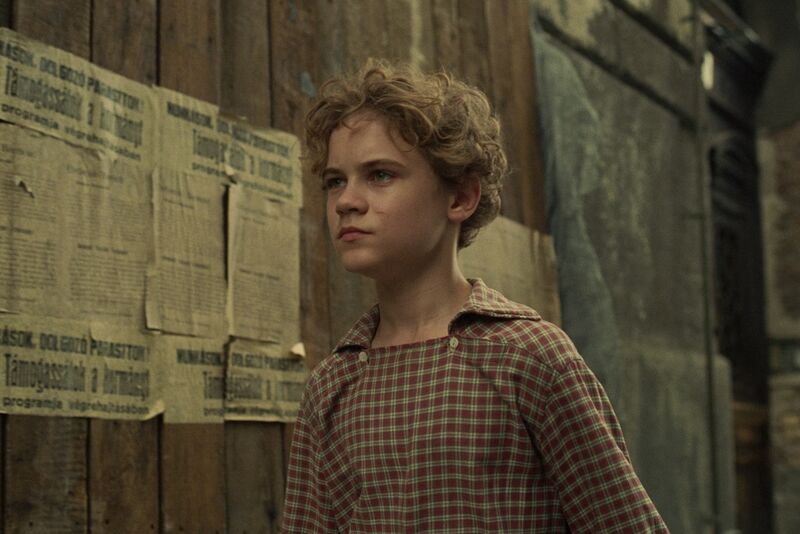 A young boy in a street in 1950s fashion