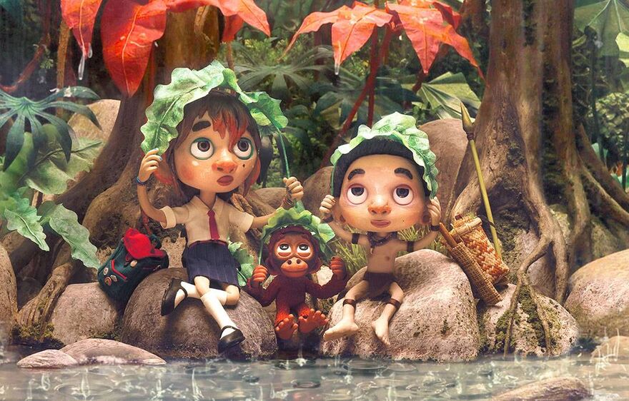 A claymation still shows two children and a monkey sitting on rocks together holding leaves over their heads.
