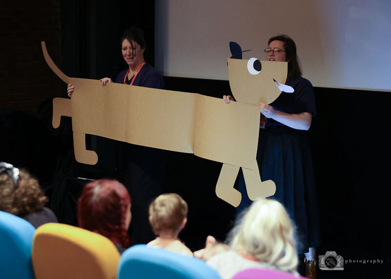 Members of the Learning team holding up a large cut out of a dog at Shorts for Tinies