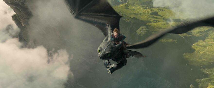 A boy rides through the sky on the back of a black dragon