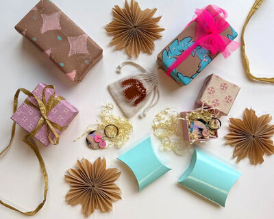 Selection of christmas gift wrap in brown, pink and blue