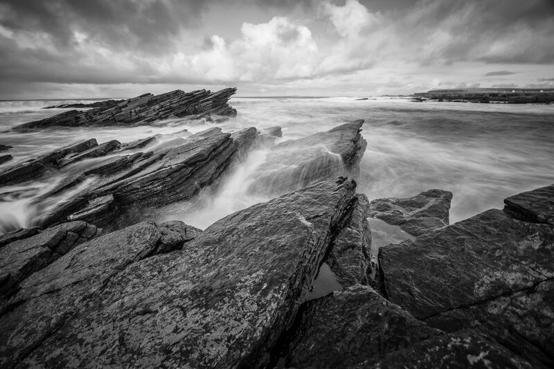 Black and white photograph of a rocky shore
