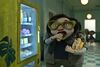 Animation still: A teen boy eating sweets from a vending machine