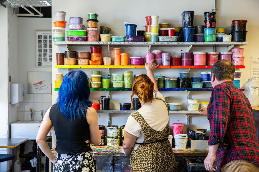People looking at shelves of ink in DCA Print Studio