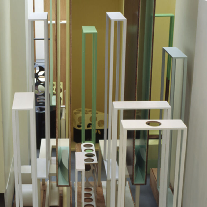 An image from Nahum Tevet/Ergin Çavuşoğlu's exhibition shows a sculpture made out of long, thin frames of plywood. Some of these frames have hollowed-out circles inside them. They are painted green and white.