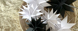 Basket full of black and white stars made from card