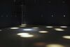 From Jim Campbell's exhibition. In a dark room, spotlights are projected on to the floor.