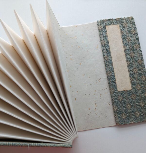 Accordion style album with cloth cover made from Japanese kimono fabric