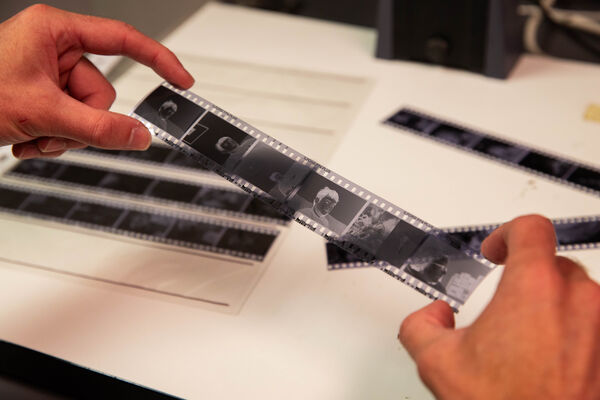 Two hands holding a black and white film strip