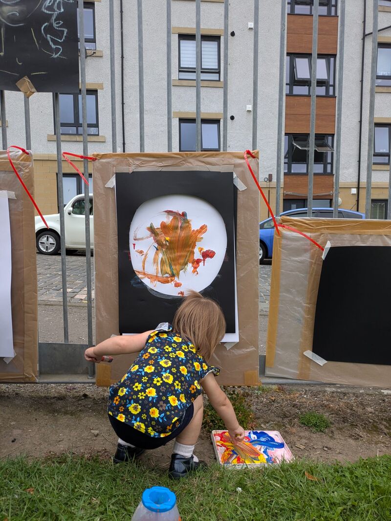 Child making a circular painting 