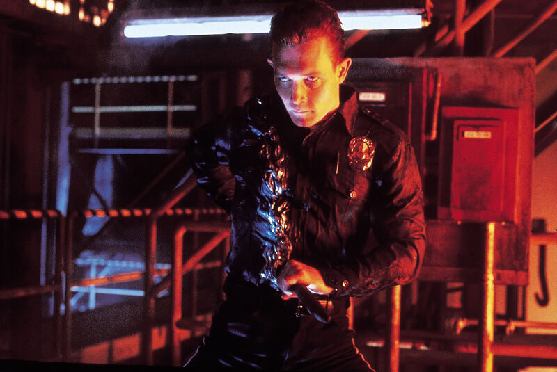 A sinister man in a police uniform pulls a metal pole from his Liquid Metal torso