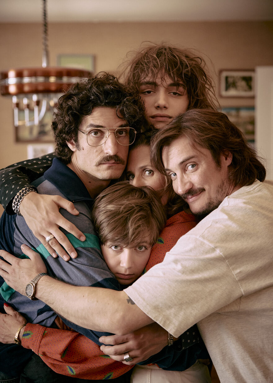 A family of four hugs and smiles