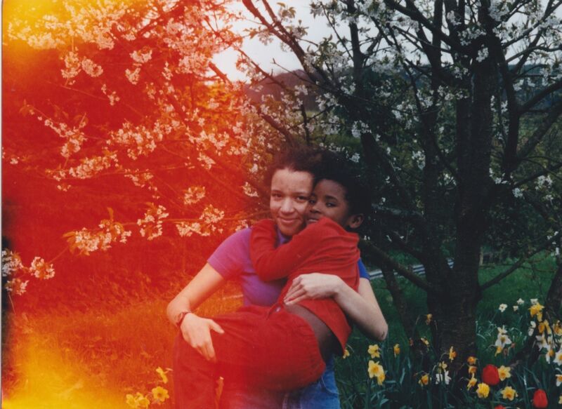 A photograph of a woman holding a child