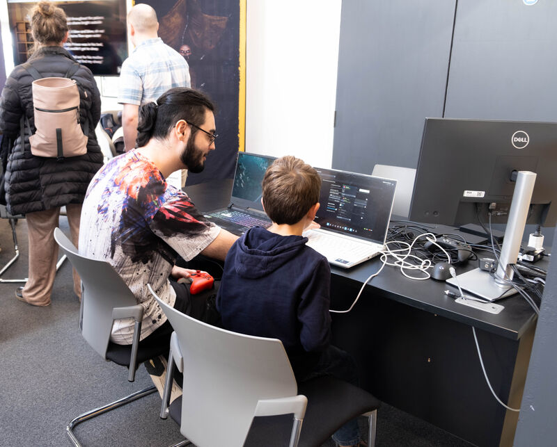 Two people play a game together at Drop in and Play