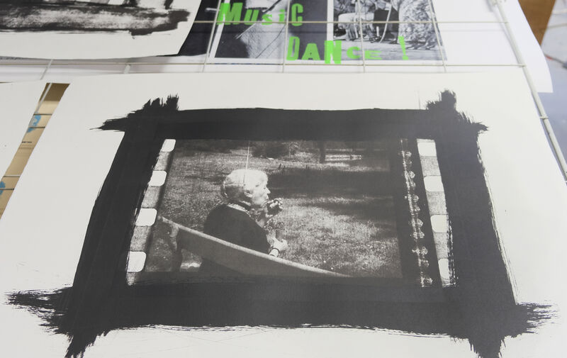 Black and white print of a lady blowing bubbles with a think black brush stroke border