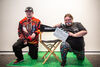 Two members of Options in Life group posing with a Director's chair and clapper board
