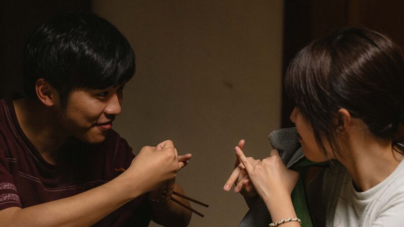 Two people talk in sign language to themselves.