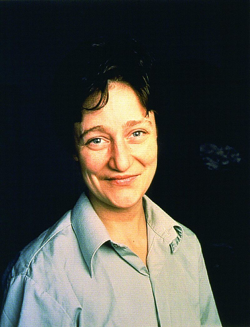 From The Eye of the Beholder - a photograph of a person smiling against a black background.