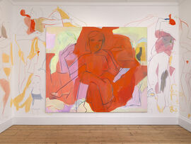 A large canvas on a wall with the painted images of women spilling onto the wall itself