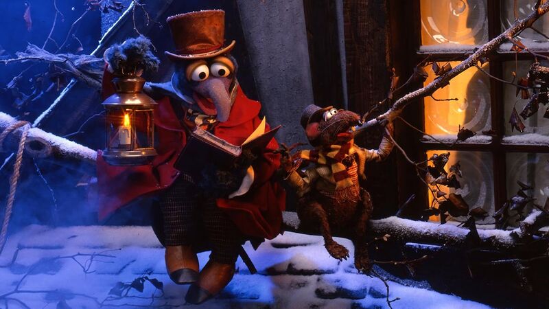 Gonzo and Rizzo the Rat dressed in Dickensian costume on a snowy rooftop