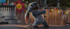 Stitch, a cute blue fluffy alien, dances on top of a bar.