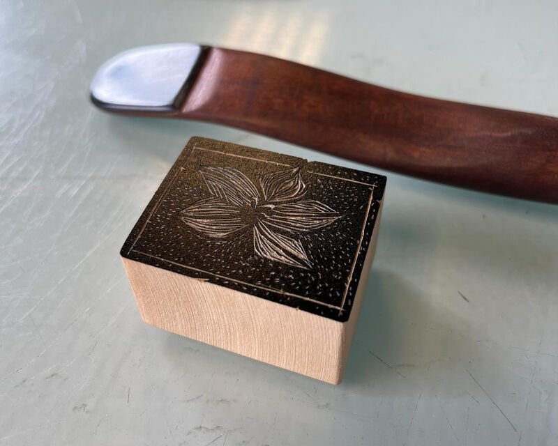 Pice of wood carved with a flower design