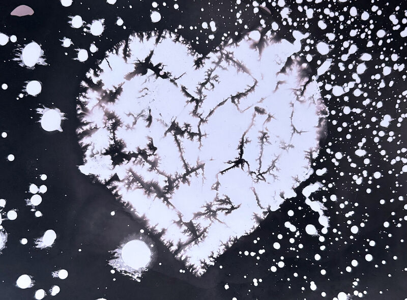 Black and white chemigram with a heart shape
