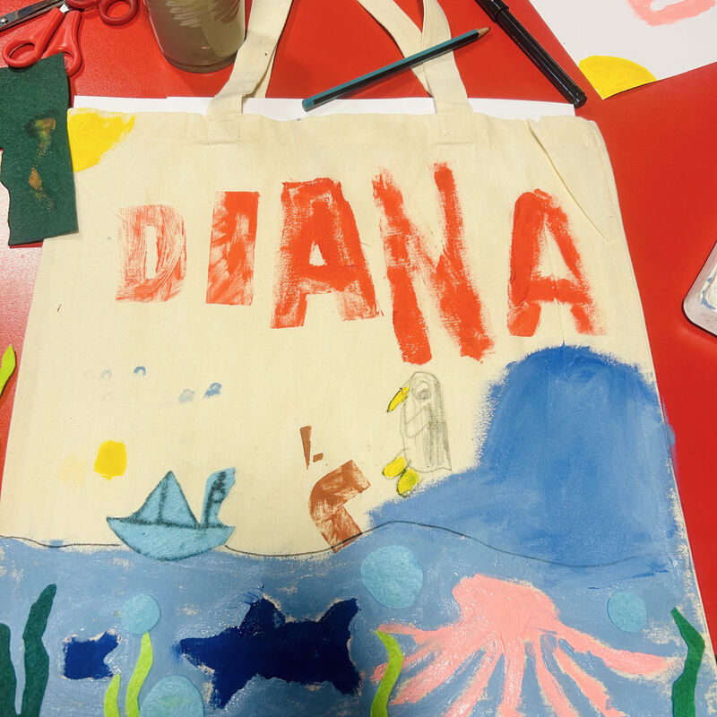 Tote bag painted with a sea scene and the name DIANA in orange letters
