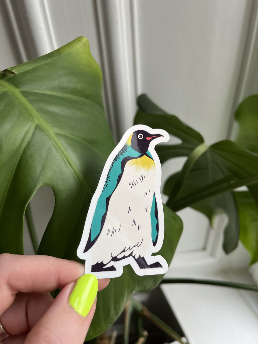 Gand holding a penquin sticket