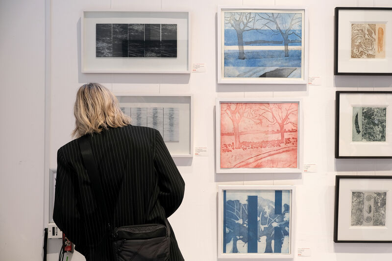 Person looking at framed prints