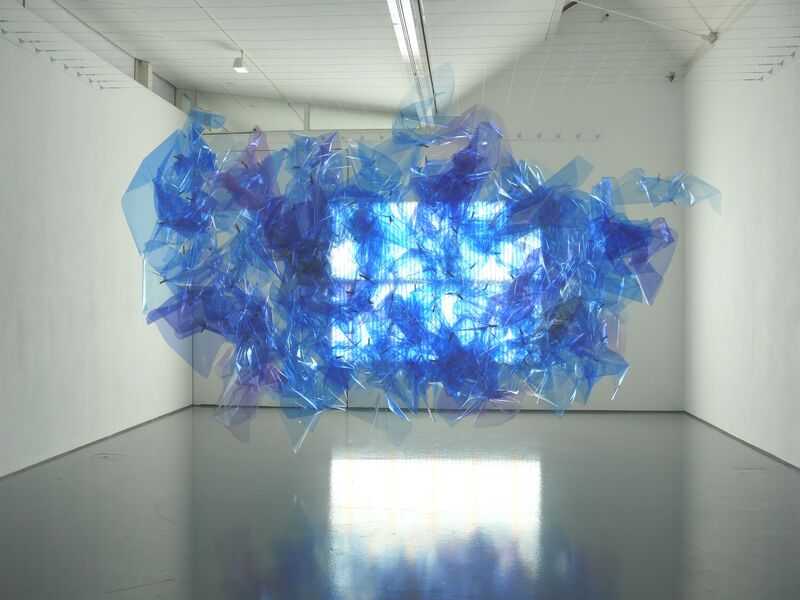 From Spencer Finch's exhibition. A large, blue sculpture made of translucent material, which reflects the light.