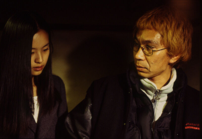 A  man looking at a young woman