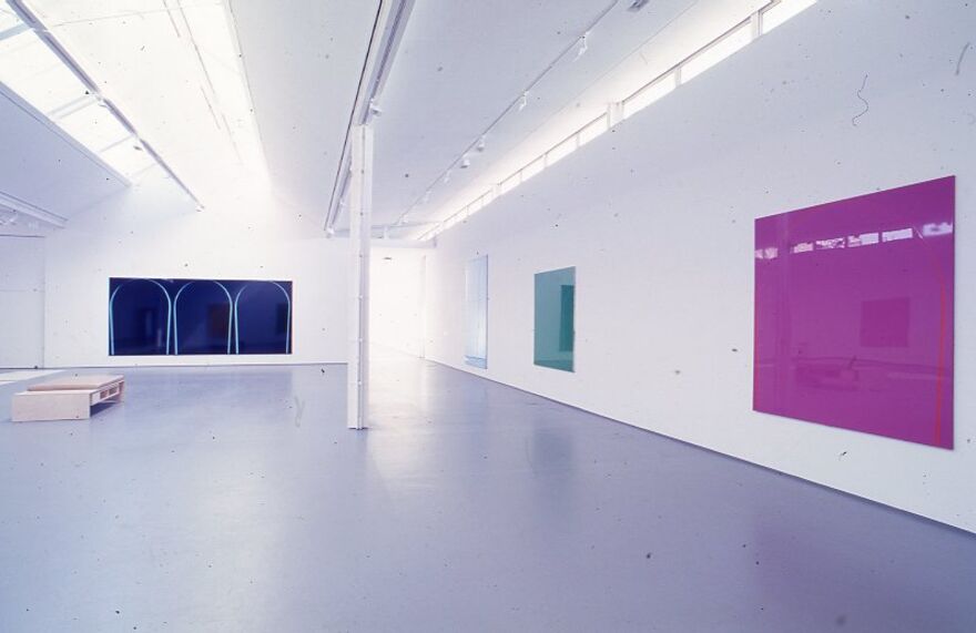 DCA Galleries during Ian Davenport's exhibition. There are three canvases on the wall, all of which are single colours - pink, blue and black.