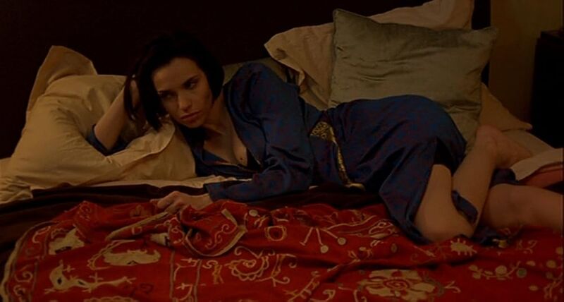 Woman lying on a bed wearing a night gown